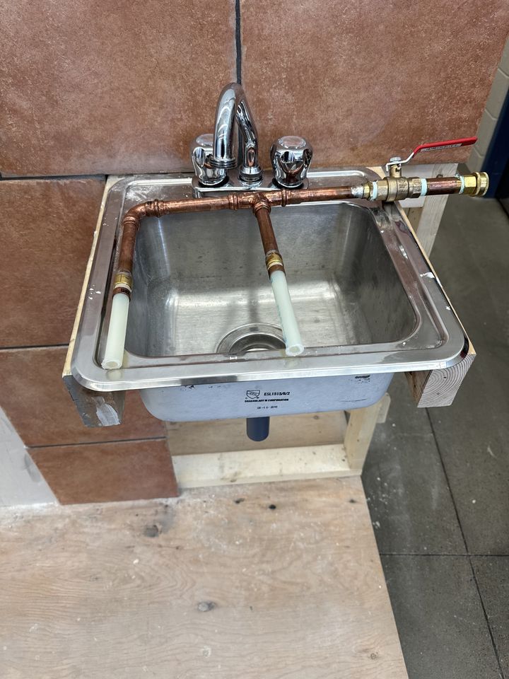 Plumbing: students working on plumbing